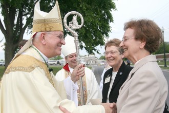 Archbishop Joseph E. Kurtz, left, greeted, from left, Ursuline Sisters of Mount St. Joseph Amelia Stenger and Susan Mary Mudd on April 29 in front of the David R. Hourigan Government Building in Marion Co., Ky. Bishop William Medley of Owensboro stood in the background. Last weekend, the Ursuline Sisters of Mount St. Joseph celebrated their centennial in Marion County, where the sisters served in education. (Photos by Stephen Lega, The Lebanon Enterprise)