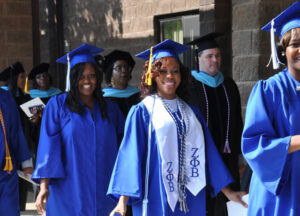 Spalding University awarded 586 undergraduate and graduate degrees at its commencement exercises June 6. Graduates, left, processed into Canaan Christian Church, 2840 Hikes Lane. Others took time to stop for a quick photo, below, before the ceremony began. (Record Photos by Jessica Able)