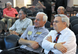 Members of the Serra Club watch the live feed of the canonization of St. Junipero Serra.