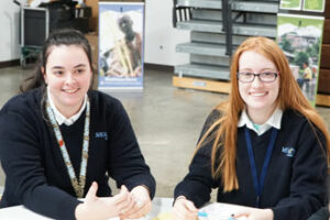 Ashley Baker, left, and Caitlyn Tumey, both juniors at Mercy Academy, participated in a table discussion at the Catholic Relief Services Rice Bowl kick-off luncheon held at DeSales High School Feb. 2. (Record Photo by Jessica Able)
