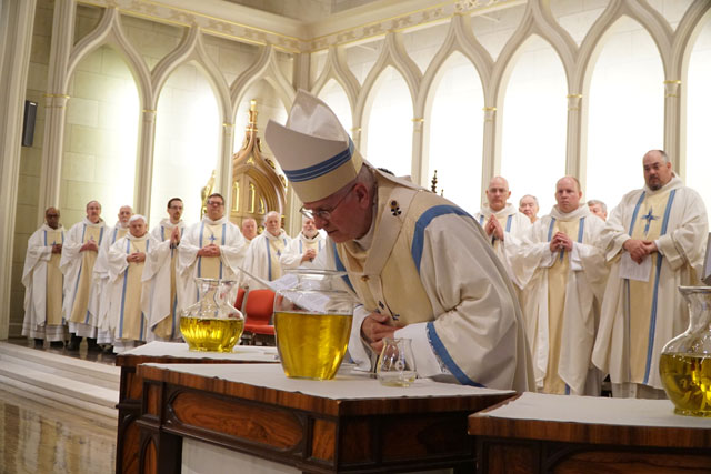 Archbishop Joseph E. Kurtz breathed on the sacred Chrism during its consecration March 22 at the annual Archdiocese of Louisville Chrism Mass, celebrated at the Cathedral of the Assumption. (Record Photo by Marnie McAllister)
