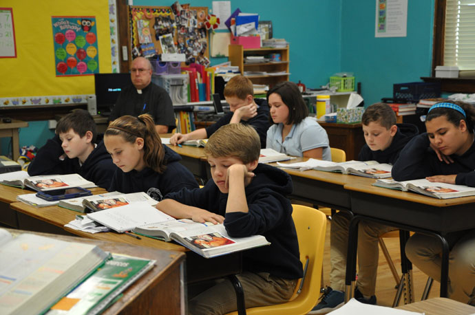 Middle school students at St. Catherine Academy in New Haven, Ky., read from their books during class on Nov. 5, 2015. The school in Nelson County has seen a 15 percent increase in student enrollment during the course of the last year. (Record File Photo by Jessica Able)