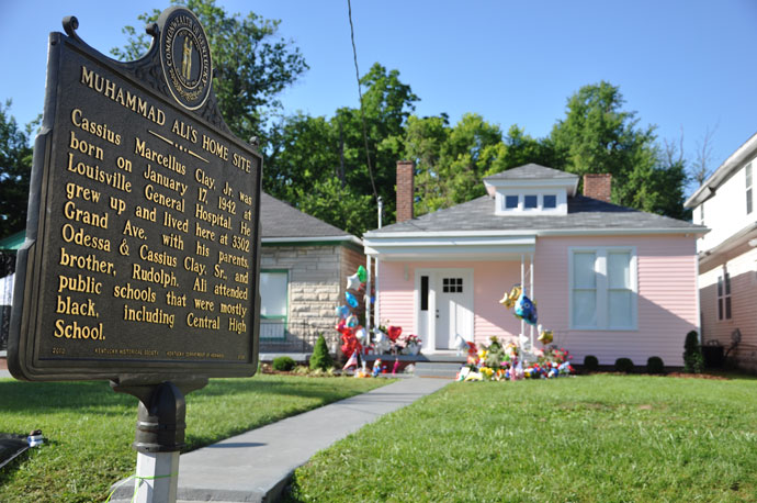 Memorials honoring the late Muhammad Ali stand in front of the boyhood home of the three-time heavyweight champion. The house, located at 3302 Grand Avenue, was recently restored and it opened to the public for tours on May 28. (Record Photo by Jessica Able)
