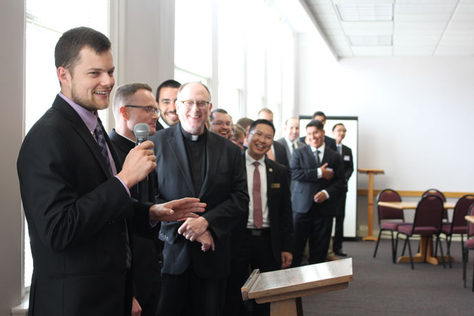Seminarian David Ferrell discussed his summer assignment as his fellow seminarians looked on during an annual luncheon sponsored by Serra Club on Aug. 11. The club, whose mission centers on promoting vocations, holds a luncheon for seminarians each year, providing an opportunity for club members and archdiocesan leaders to meet and learn about the seminarians’ formation. The archdiocese currently has 19 seminarians heading back to school over the next couple of weeks. (Record Photo by Marnie McAllister)