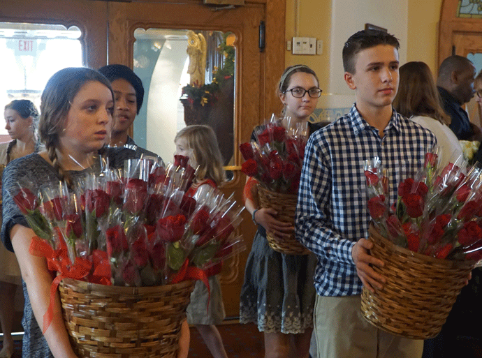 Elizabeth Guyer and Aaron McGraw, front from left, and Joshua Bagaipo and Cecilia Norton, back from left, all confirmandi of St. Martin of Tours Church, took part in the offertory procession during the annual Memorial Mass for Life Jan. 22 at St. Martin of Tours in downtown Louisville. (Record Photo by Jessica Able)