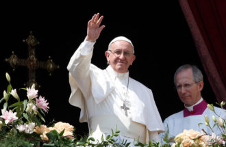 Pope Francis greets the crowd after delivering his Easter message and blessing "urbi et orbi" (to the city and the world) from the central balcony of St. Peter's Basilica at the Vatican April 16. (CNS photo/Paul Haring)