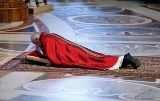 Pope Francis lies prostrate as he leads the Good Friday service in St. Peter's Basilica at the Vatican April 14. (CNS photo/Paul Haring)