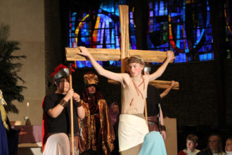 St. James School in Elizabethtown, Ky., performed the annual Passion play on Holy Thursday, April 13. Jesus, portrayed by Matthew Barnes, is shown in the last moments before his death on the cross, above right. (Photo Special to The Record)