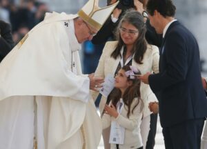 Pope Francis accepts offertory gifts during the canonization Mass of Sts. Francisco and Jacinta Marto, two of the three Fatima seers, at the Shrine of Our Lady of Fatima in Portugal May 13. The Mass marked the 100th anniversary of the Fatima Marian apparitions, which began on May 13, 1917. (CNS photo/Paul Haring) See POPE-FATIMA-CANONIZATION May 13, 2017.