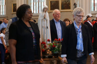 A statue of Our Lady of Fatima was carried in the opening procession of a rosary and Mass May 13 honoring the centennial of the appearance of Mary to three children in Fatima, Portugal. (Record Photos by Marnie McAllister)