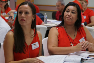 Alba Martín, left, and Mary Coadros listened during a presentation at the first parish Encuentro held June 25 at St. James Church in Elizabethtown, Ky. (Record Photo by Ruby Thomas)