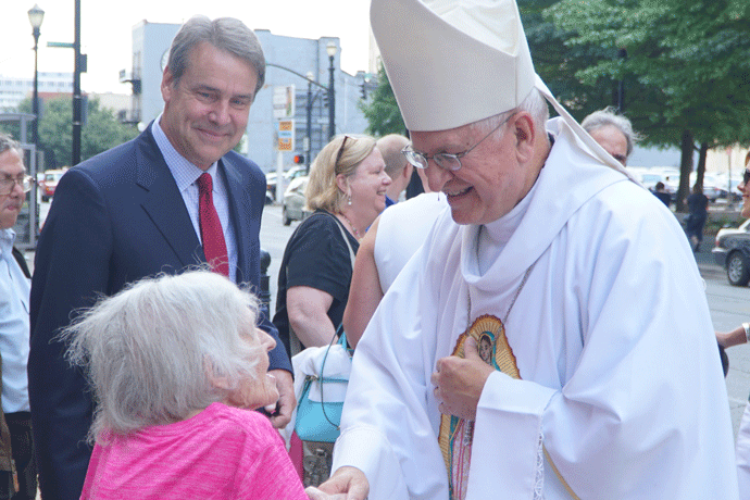 Archbishop Joseph E. Kurtz greets Martha Cawson following a Mass commemorating the solemnity of the Assumption of the Blessed Virgin Mary Aug. 15 as Richard A. Lechleiter, president of the Catholic Education Foundation, looked on. The day also marked the 10th anniversary of the installation of Archbishop Kurtz as the ninth ordinary of the Archdiocese of Louisville. (Record Photo by Jessica Able)