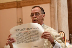 Archbishop Charles C. Thompson displayed a letter from Pope Francis naming him the seventh archbishop of the Archdiocese of Indianapolis during his installation Mass July 28.