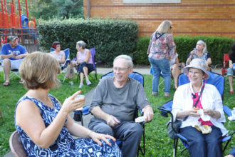 Parishioners of St. James Church, from left, Mary Pat Nimon, Bob Van Bruggen and Joyce Van Bruggen, enjoyed live music at the St. James Beer Garden Summer Series Aug. 18. The social events were created by the parish’s stewardship committee as an outreach effort to parishioners and their Highlands neighbors. St. James was one of six parishes that recently completed a parish discernment process, which asked them to consider “How is God asking us to grow?” (Record Photo by Jessica Able)