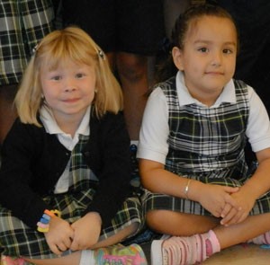 Two kindergarten students waited to get a new student group photo taken. Record Photo by Ruby Thomas