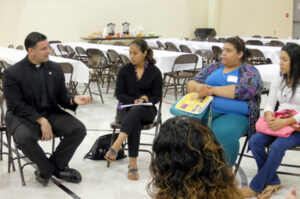 Father Raphael Capó led a young adult discussion group. Record Photo by Ruby Thomas