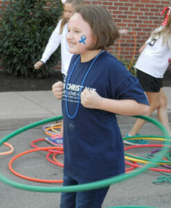 A student dances the hula hoop during a carnival event at St. Margaret Mary.