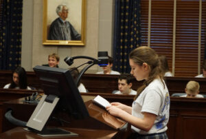 Anna Federico, an eighth-grader St. Aloysius School in Pewee Valley, Kentucky, played the role of Atticus Finch in a reenactment of Harper Lee’s “To Kill a Mockingbird” trial scene Feb. 19 at the Gene Snyder Courthouse.