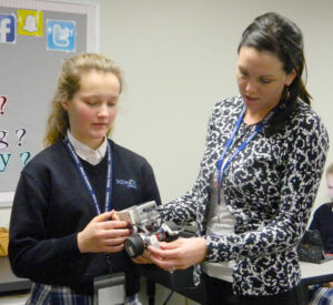 Mercy Academy freshman Tessa Duncan, left, and teacher Kristen Chavez worked with a robot built by students during an introductory STEM class.  (Record Photo by Ruby Thomas) 