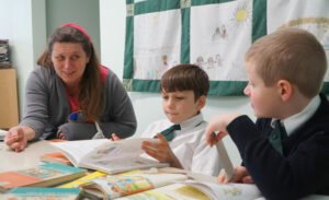 Marina Traub, a kindergarten and first grade teacher, worked on reading with first-graders Lochlan McCarthy, left, and Caden Maskey. (Record Photo by Ruby Thomas)
