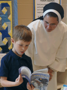 Sister Augusta Nickel, a Dominican Sisters of St. Cecilia, shared a book with Cole Marden, a first-grader in Sister Maria Clemens Wolf’s classroom Aug. 11 at St. James School in Elizabethtown, Ky. Sister Nickel is the director of formation and education at the church. (Record Photo by Ruby Thomas)