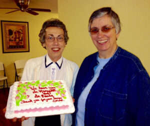 Sister Margaret Held, left, and Paula Merrill are pictured in an undated photo with a cake celebrating their service.