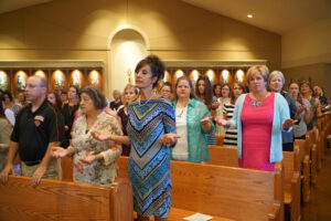 Teachers pray the "Our Father" at the annual liturgy held prior to the start of the school year, at St. Lawrence Church in this August, 2016 photo. (Record File Photo by Jessica Able)