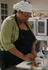 Tracy Malone, a student in Catholic Charities’ of Louisville’s Common Table Culinary Arts program, sliced strawberries for a strawberry shortcake to be served at the Garden Cafe Aug. 23. The Garden Cafe serves lunch to the public on Tuesdays and Thursdays. Watch the video at therecordnewspaper.org. (Record Photo by Ruby Thomas)