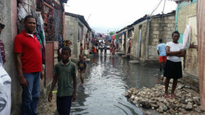 Residents stand outside their homes Oct. 5 in Cite Soleil, a slum in Port-au-Prince, Haiti, after Hurricane Matthew swept through the island nation. Rescue workers in Haiti are struggling to reach parts of the country cut off by Hurricane Matthew, the most powerful Caribbean storm in nearly a decade. (CNS photo/courtesy Malteser International)