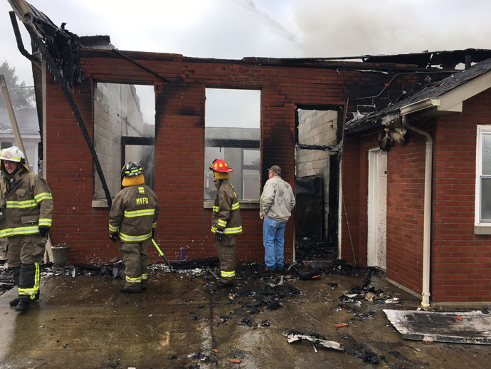 Firefighters and others inspect damage from a fire at Our Lady of the Caves Church in Horse Cave, Ky., Dec. 9. (Photo Special to The Record)