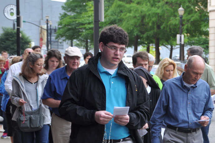 About 75 people, including Archbishop Joseph E. Kurtz, prayed the rosary during a procession to an abortion clinic in downtown Louisville May 20, as part of the Helpers of God’s Precious Infants monthly prayer vigil for life at the Cathedral of the Assumption. The Helpers marked its 10th anniversary with Mass prior to the procession. (Record Photo by Jessica Able)