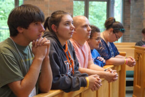 Students from Bowling Green State University in Ohio prayed before an evening Mass June 7 at Bellarmine University’s  Our Lady of the Woods Chapel. The students were participants in the national Campus Ministry Institute held June 6 to 11 at Bellarmine. (Record Photo by Marnie McAllister) 