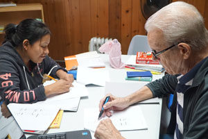  Xaverian Brother John Shaughnessy worked with Ana Perez, a Guatemalan native learning English, at Doors to Hope Oct. 12. (Record Photo by Ruby Thomas)