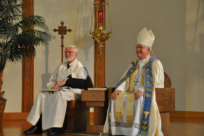 Archbishop Joseph E. Kurtz, right, and Deacon Patrick Wright, pastoral administrator of Holy Family Church, sat in the sanctuary during an Oct. 28 event to bless the new Archdiocese of Louisville Pastoral Center, which is situated on Holy Family’s campus. (Record Photo by Jessica Able)