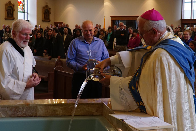 Archbishop Joseph E. Kurtz, above, blended and blessed water from three rivers that run through different parts of the Archdiocese of Louisville to bless the new Pastoral Center Oct. 28. The water, blessed at Holy Family Church which shares its campus with the new center, came from the Ohio, Cumberland and Green rivers. (Record Photo by Ruby Thomas)