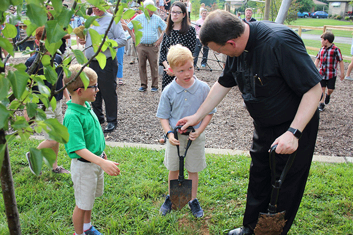Students plant trees to honor late teacher