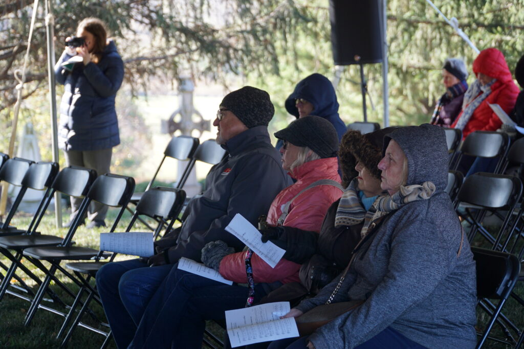 Bundled against a cold breeze on Nov. 2, Catholics attended a special All Souls’ Day Mass at Calvary Cemetery. The Mass, organized each year by Catholic Cemeteries, commemorates those who have died. (Record Photo by Marnie McAllister)